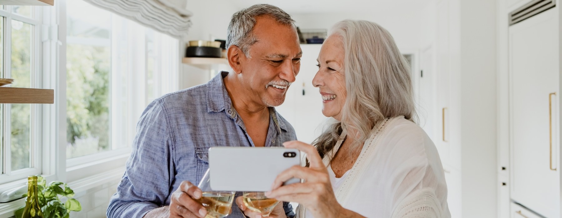 a man and a woman holding a phone and smiling