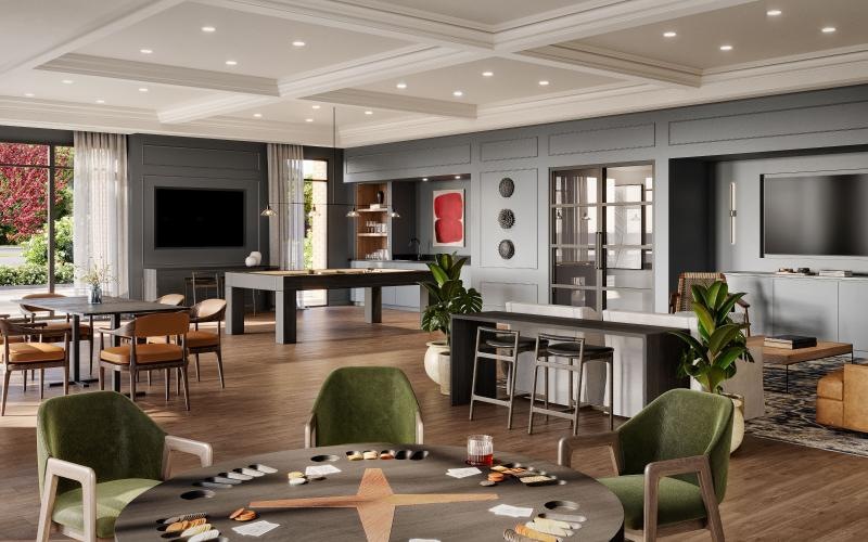 a game room with a tv, tables and chairs